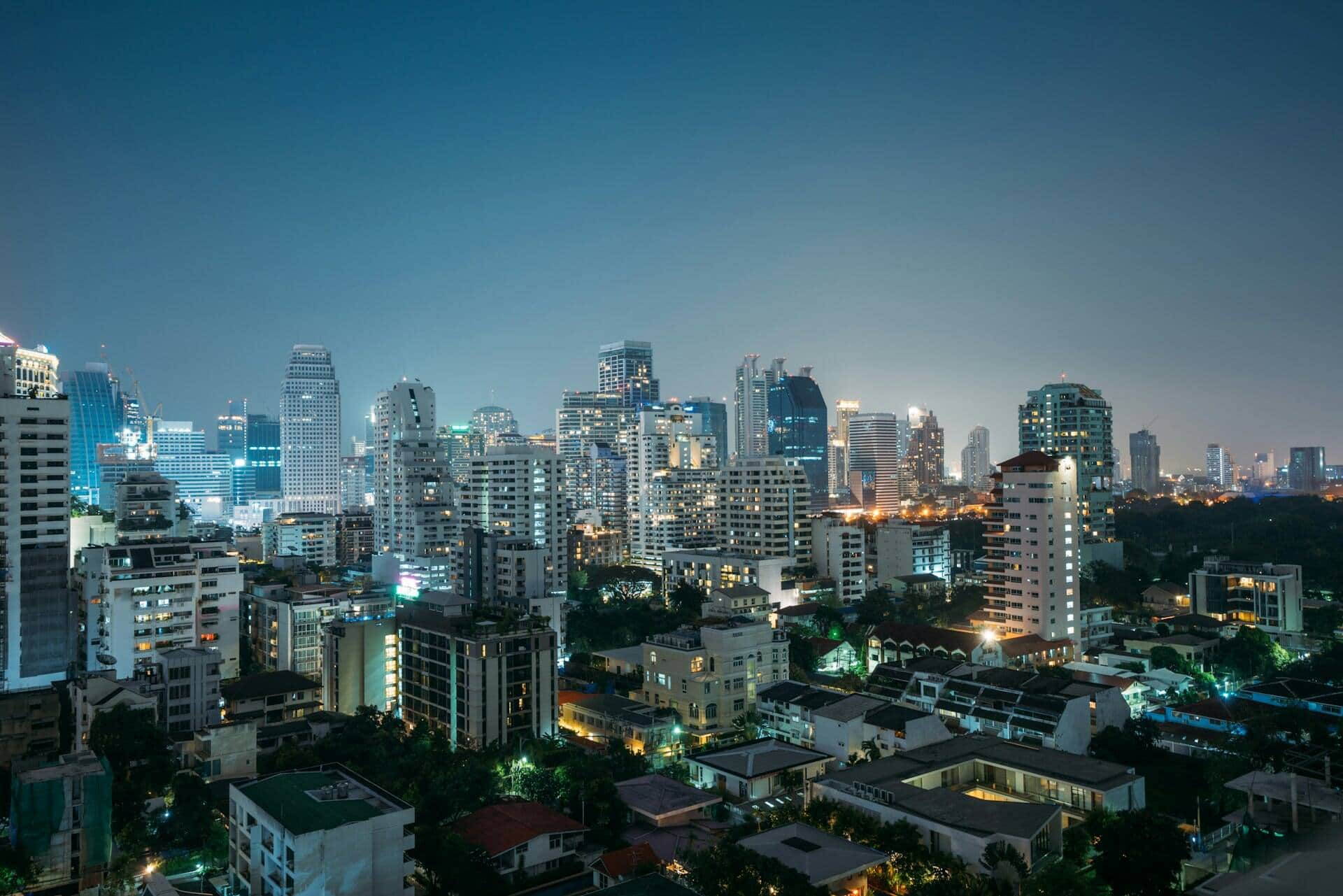 Bangkok Sukhumvit high-rise skyline at blue hour under a deep navy sky