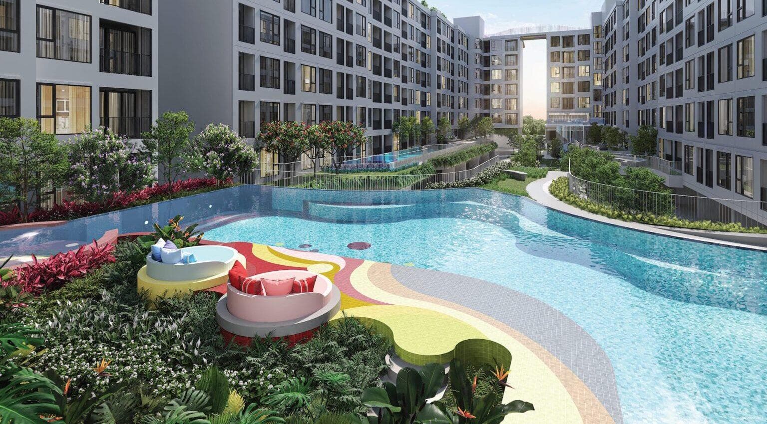 Resort-style courtyard swimming pool at Atmoz Canvas Rayong with curved mosaic sun terrace, poolside daybeds and tropical planting enclosed by the residential wings (computer-generated render)