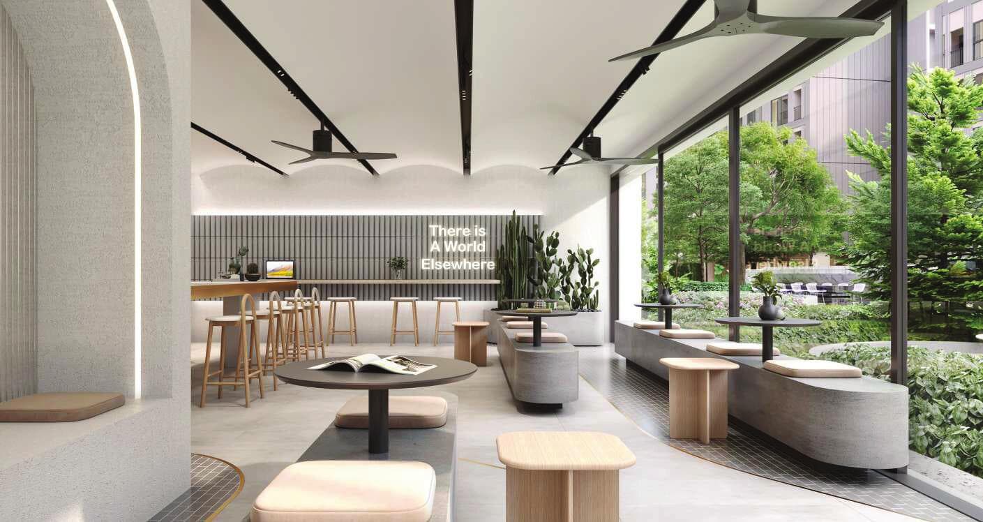 Developer render of the co-working lounge at Atmoz Oasis Onnut, with counter seating, low tables and full-height glazing onto the garden