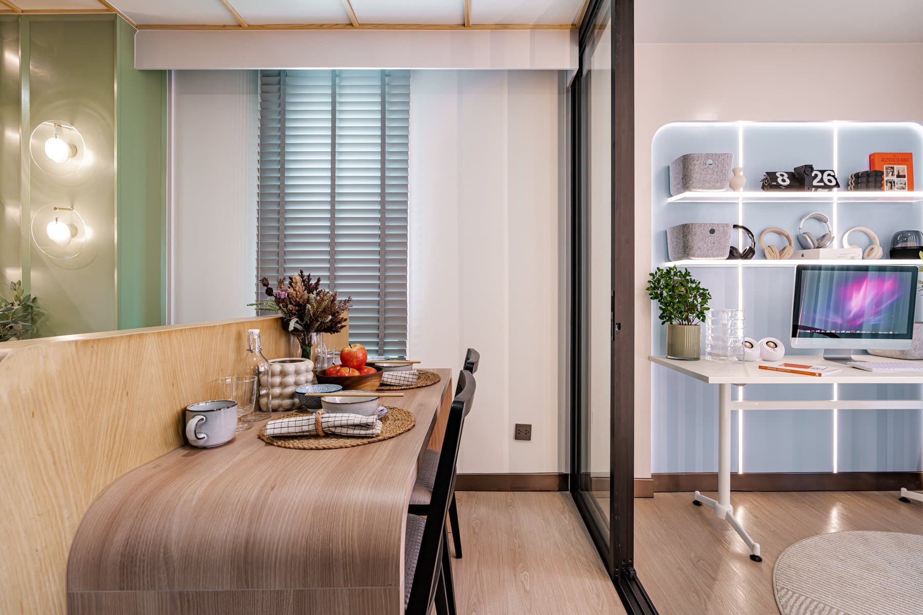 Study corner in a furnished show unit at Atmoz Season Ladkrabang, with a timber desk, a white shelving unit and a sage green wall