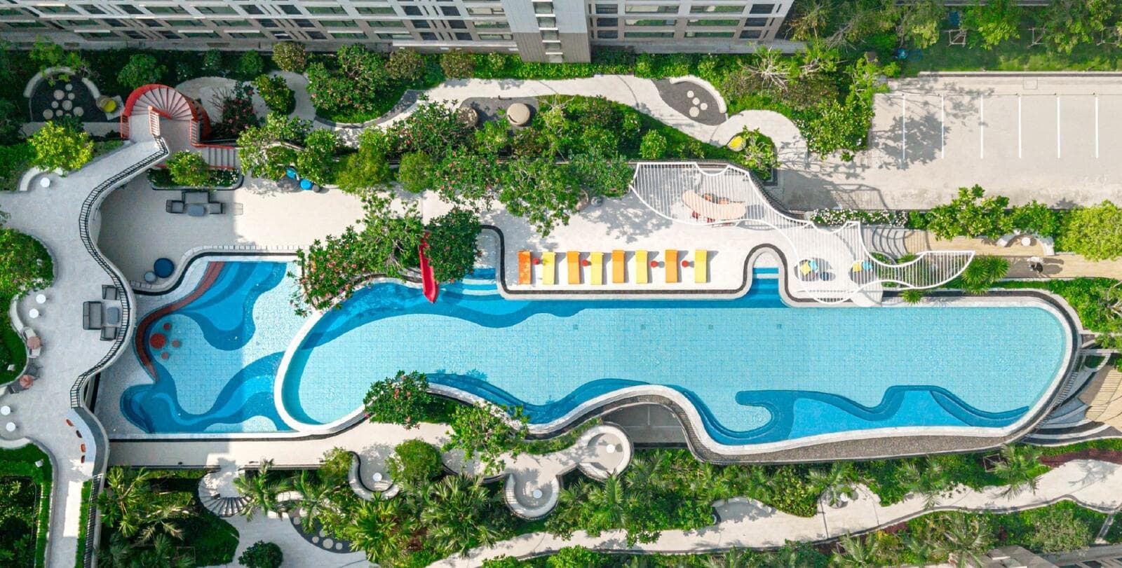 Overhead photograph of the completed central lagoon pool, sun-lounger terrace and landscaped walkways at Kave COCO Bangsaen.