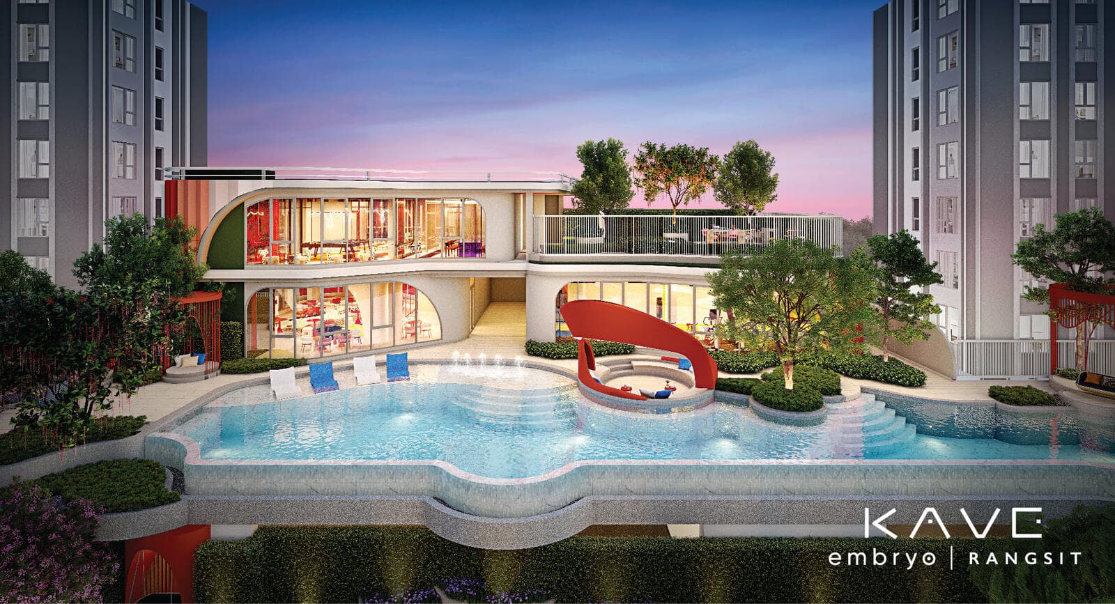 Swimming pool at KAVE Embryo Rangsit at dusk, with the curved two-storey clubhouse and its lit glass facade behind the water