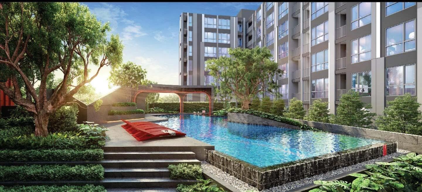 Developer computer-generated render of the lap pool and landscaped courtyard set between the two buildings at Maroon Ratchada 32, with stone-clad pool edge, terraced steps and mature feature trees.