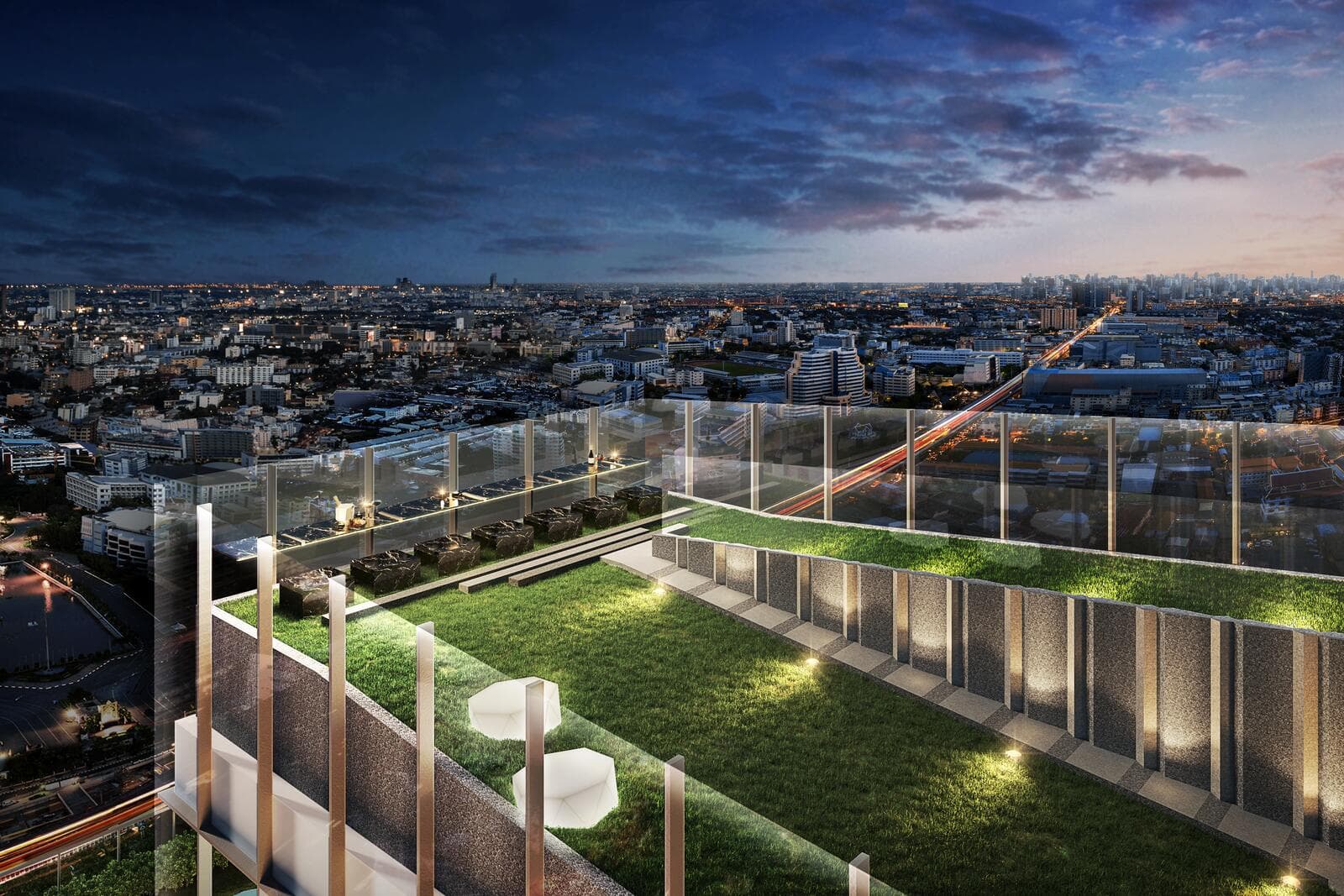 Rooftop sky lawn at Modiz Rhyme Ramkhamhaeng at dusk, with a glass-balustraded edge, stepped seating terrace and sculpted white chairs overlooking the Bangkok skyline (computer-generated render)