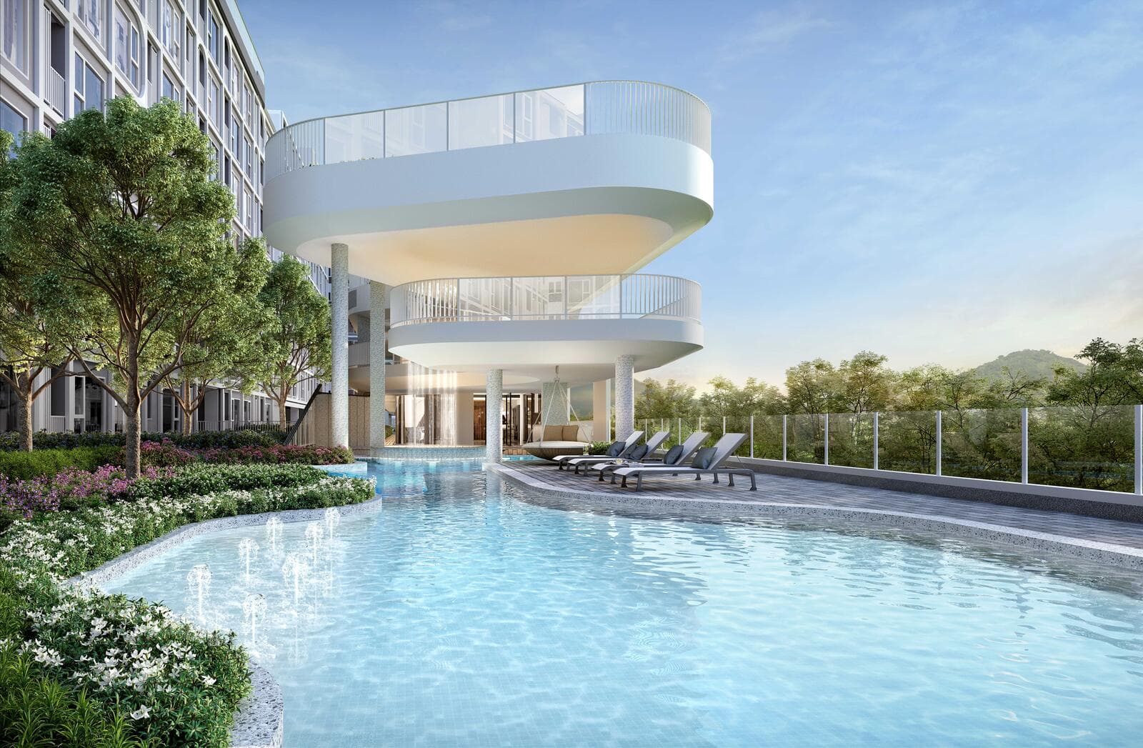 Outdoor swimming pool with water jets and sun loungers beneath the curved cantilevered clubhouse terraces at Atmoz Serene Sriracha