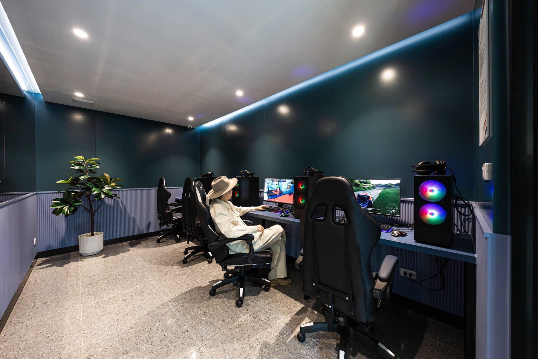 E-sports room at Kave COCO Bangsaen with rows of gaming chairs, dual monitors and coloured task lighting
