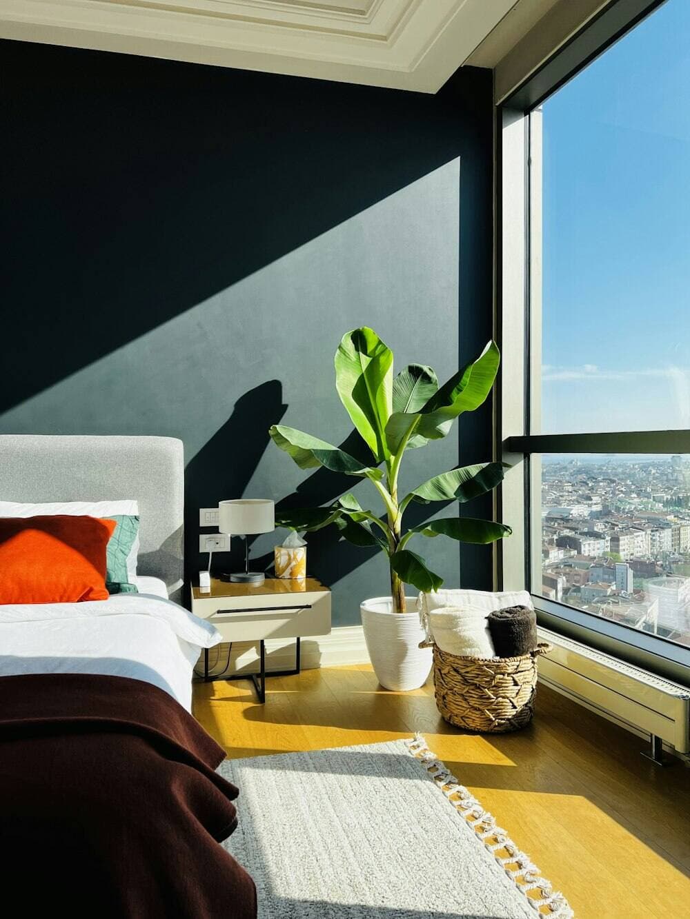 Bedroom with floor-to-ceiling windows over the Bangkok skyline